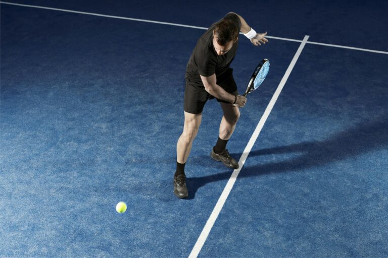 Padel player on a blue padel court
