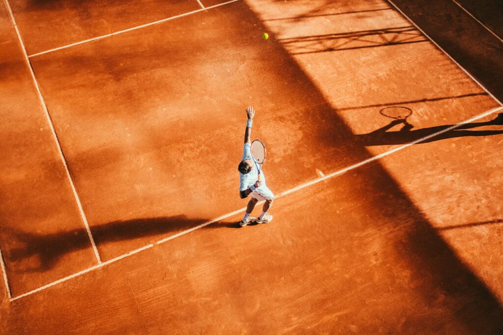 Tennis racket and ball on clay
